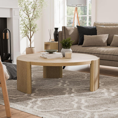 Round oak coffee table with sculptural plinth base, front view