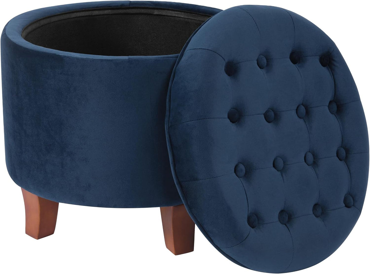 Navy velvet storage ottoman used as a footrest beside a sofa