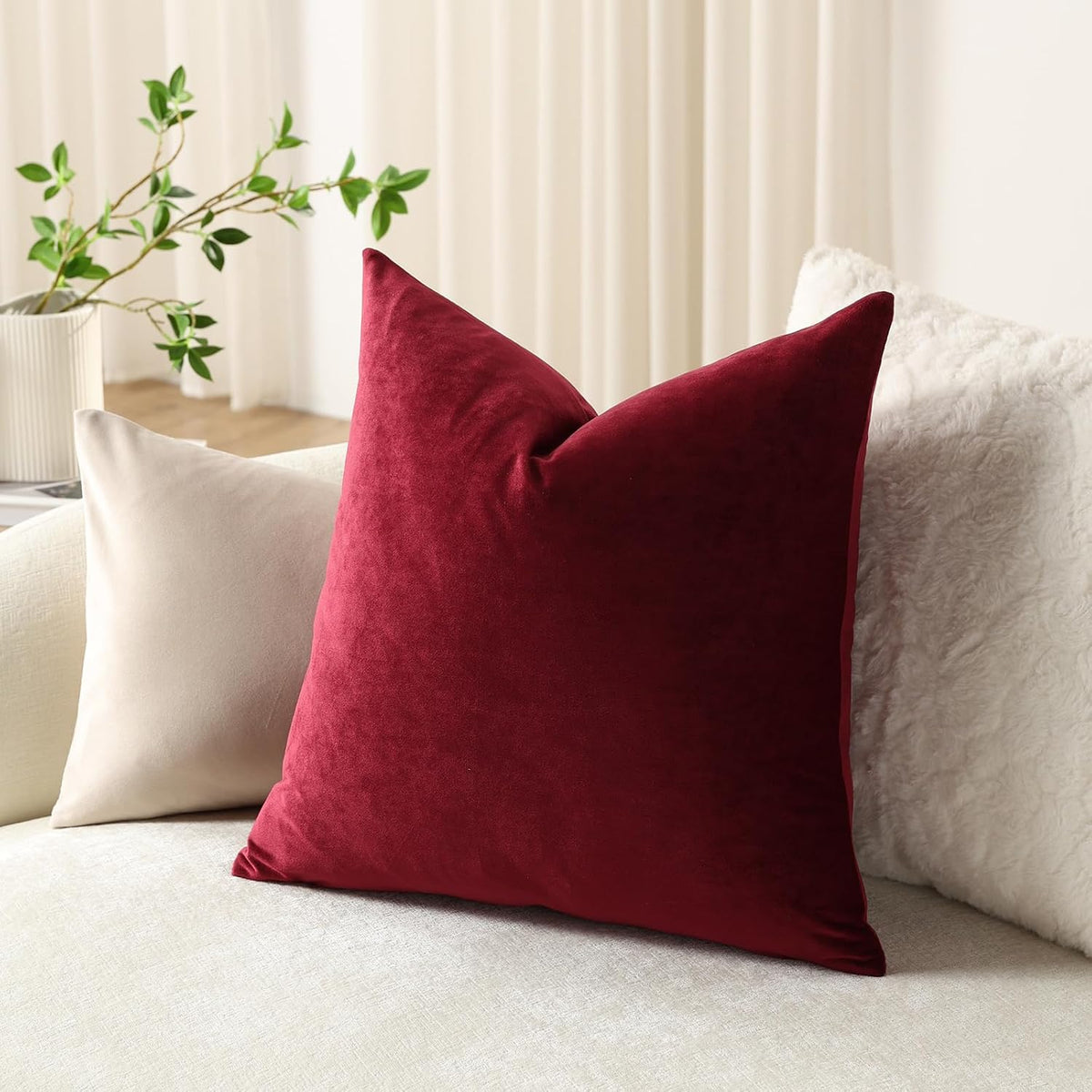 DEZENE wine red velvet pillow covers styled on a bed
