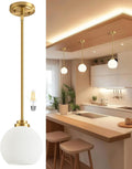 Majade brushed brass globe pendant light with milk glass shade
