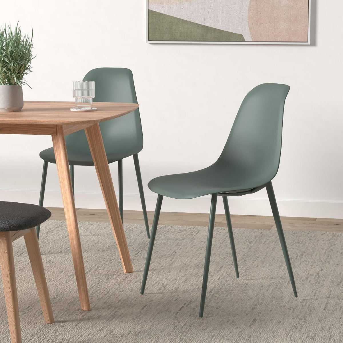 Pistachio green molded dining chair, angled view showing metal legs