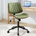 Curved sage green faux leather armless desk chair with walnut wood back and black metal swivel base, front view in a home office