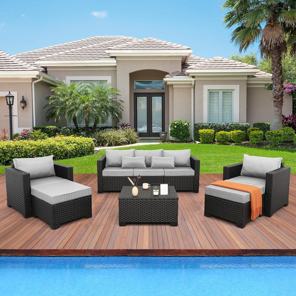 Black wicker outdoor sectional set, angled view showing armchairs and sofa section