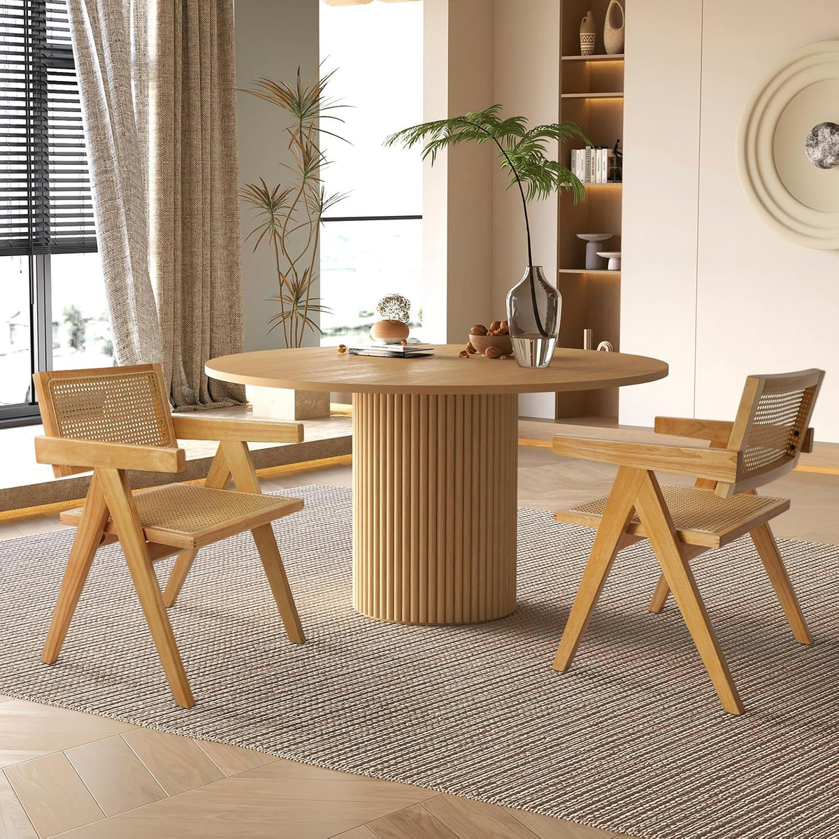 Round dining table with fluted solid wood pedestal base, styled with woven cane chairs