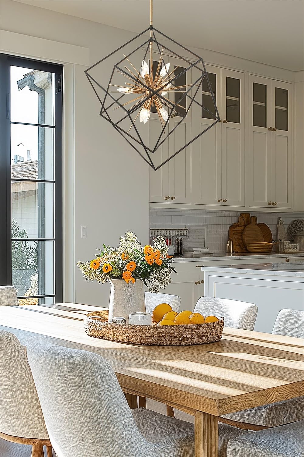 Kira Home chandelier illuminated over dining table