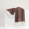 Chocolate brown and cream herringbone woven throw blanket with cream fringe, draped and photographed on a white background