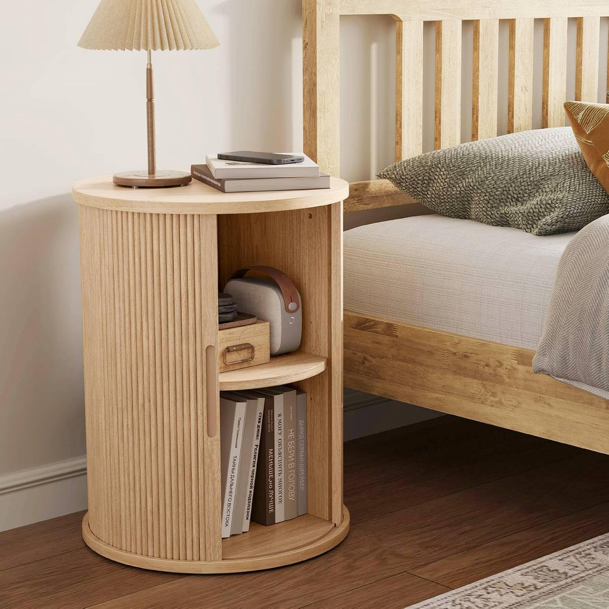 Fluted round oak end table styled beside a sofa in a living room