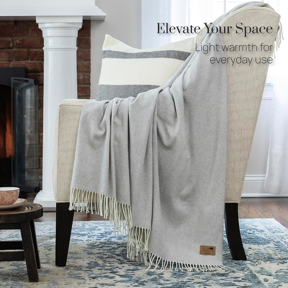 Throw draped across the corner of a bed in a softly lit bedroom