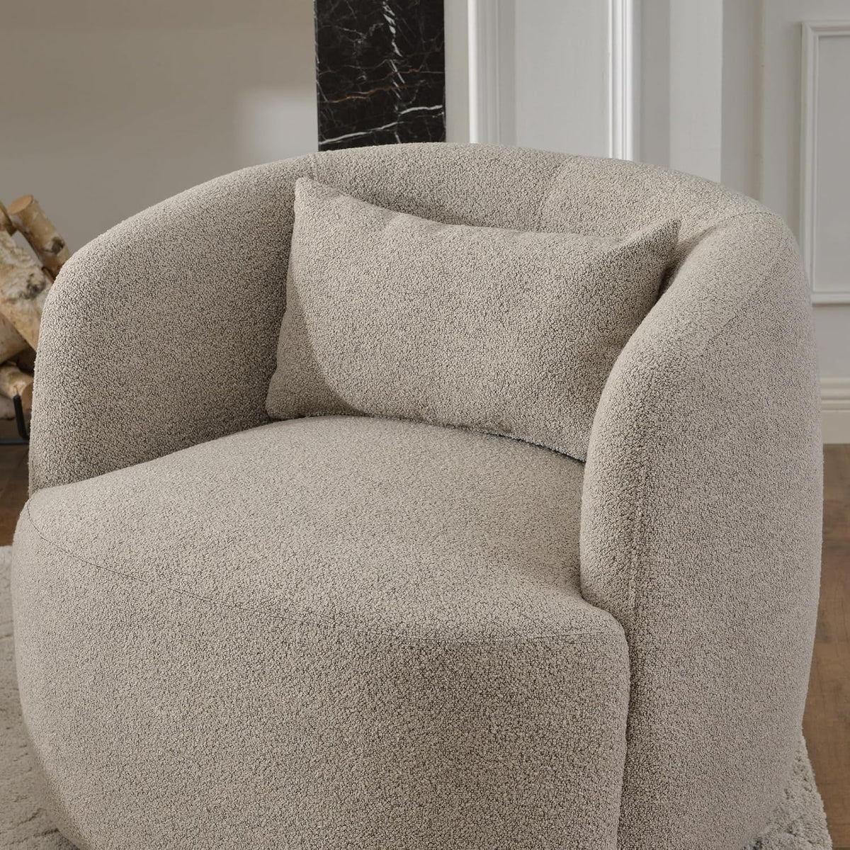 Two boucle swivel barrel chairs styled together in a bedroom