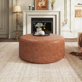 Round faux leather ottoman, cognac brown, front view
