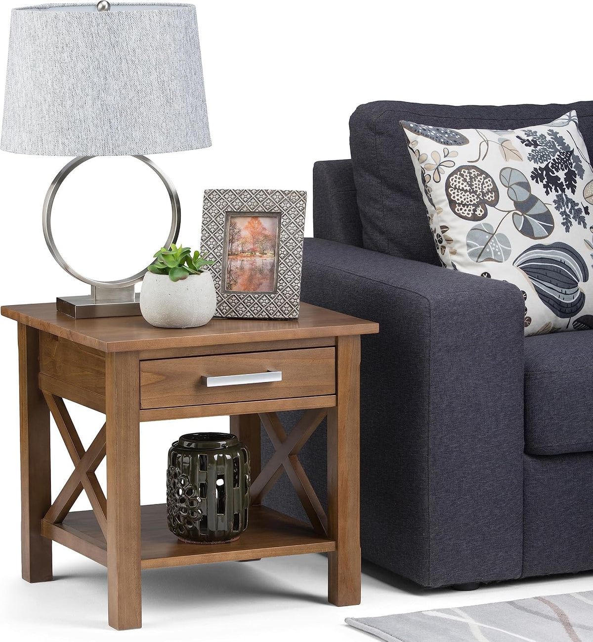 X-design solid wood end table shown beside a sofa